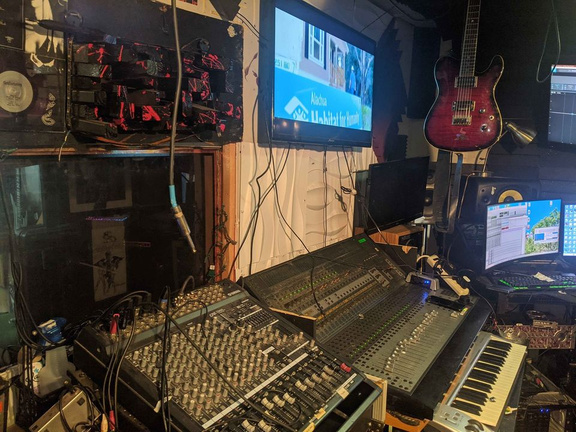 an image of a recording studio with a keyboard and a monitor