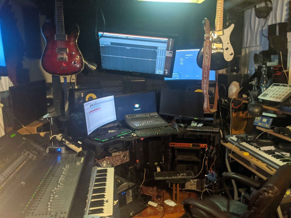 a music studio with a keyboard, guitar, and other musical instruments